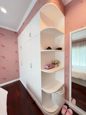 a bedroom with pink walls and white shelves at RisaVilla Phuket - 4BR Pool Villa near Patong Beach in Patong Beach