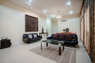 a living room with a couch and a table at Number Nine Pool Villa in Ban Tha Rua