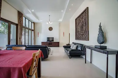 a living room with a couch and a table at Number Nine Pool Villa in Ban Tha Rua