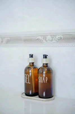 two bottles of soap sitting on a shelf at Number Nine Pool Villa in Ban Tha Rua