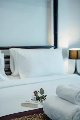 a hotel room with a bed with a book and towels at Number Nine Pool Villa in Ban Tha Rua