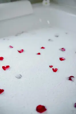 a group of red rose petals on the ground at Number Nine Pool Villa in Ban Tha Rua