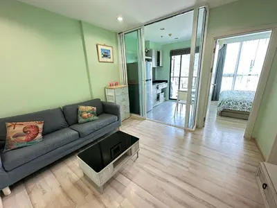 a living room with a couch and a bedroom at The Base Height in Phuket Town
