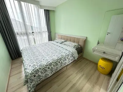a bedroom with a bed and a large window at The Base Height in Phuket Town