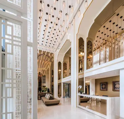 a large lobby with chandeliers and a couch at The Base Height in Phuket Town
