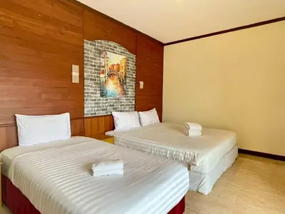 two beds in a hotel room with two bedsvisor at Maap Guest House in Patong Beach