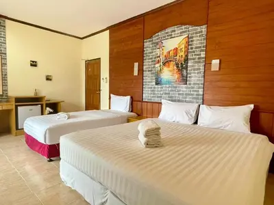 a hotel room with two beds in a room at Maap Guest House in Patong Beach