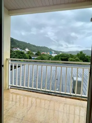 a balcony with a view of the water at Maap Guest House in Patong Beach