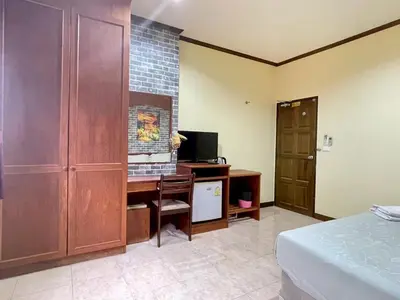 a bedroom with a desk with a computer and a bed at Maap Guest House in Patong Beach