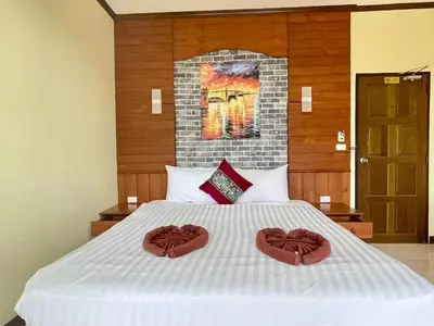 a bed with two heart towels on top of it at Maap Guest House in Patong Beach