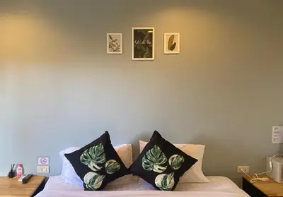 a room with a bed with two pillows on it at NR Nanai Patong in Patong Beach