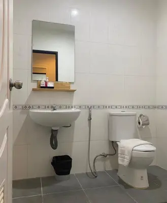 a bathroom with a toilet and a sink and a mirror at NR Nanai Patong in Patong Beach