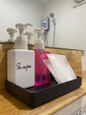 a tray with two bottles of soap and a paper at NR Nanai Patong in Patong Beach