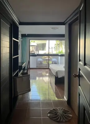 a room with a bedroom with a bed and a door at NR Nanai Patong in Patong Beach