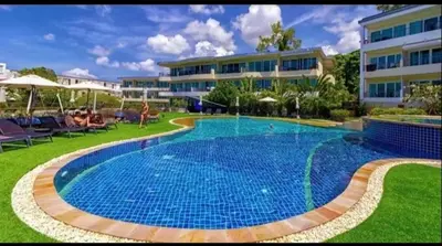 a large swimming pool in front of a building at Relaxing Apartment in Karon in Karon Beach
