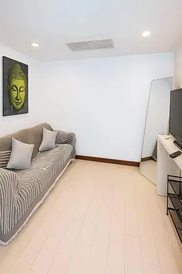 a living room with a couch and a television at Relaxing Apartment in Karon in Karon Beach