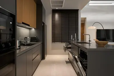 a kitchen with black cabinets and a counter top at Premium Villa Botanica 3-BR with Pool and Garden in Ban Pak Lak