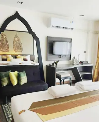 a living room with a bed and a desk at Stay Kata in Kata Beach