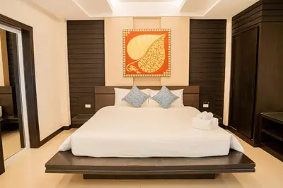 a bedroom with a white bed in a room at Lulu Hotel at The Glasshouse Lion Café in Ban Sire