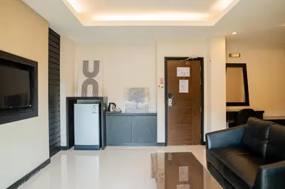a lobby with a couch and a cash register at Lulu Hotel at The Glasshouse Lion Café in Ban Sire