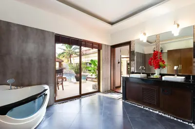 a bathroom with a tub and a sink at 6 Bedroom Villa Sri Suri with Private Pool and Butler service near Nai Harn Beach in Rawai Beach