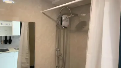 a shower in a bathroom with a shower curtain at Cozy studio Sunset view near of MaiKhao beach in Ban Mai Salae