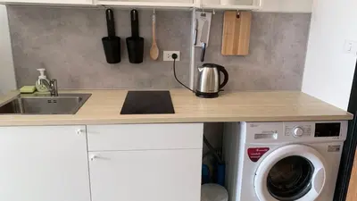 a kitchen counter with a sink and a washing machine at Cozy studio Sunset view near of MaiKhao beach in Ban Mai Salae