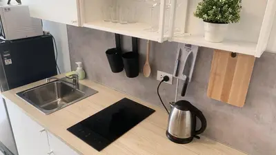 a small kitchen with a sink and a counter top at Cozy studio Sunset view near of MaiKhao beach in Ban Mai Salae