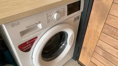 a washer and dryer sitting in a room at Cozy studio Sunset view near of MaiKhao beach in Ban Mai Salae