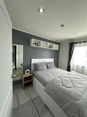 a bedroom with a large bed and a window at Modern Apartment in Chalong in Chalong