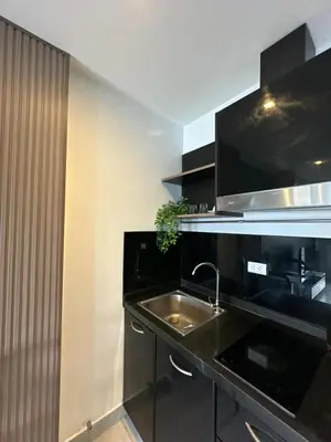 a kitchen with a sink and a counter top at Modern Apartment in Chalong in Chalong