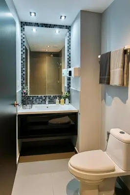 a bathroom with a toilet and a sink and a mirror at Modern Apartment in Chalong in Chalong