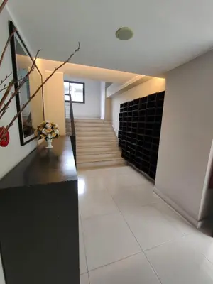 a hallway with a staircase in a house at Modern Apartment in Chalong in Chalong