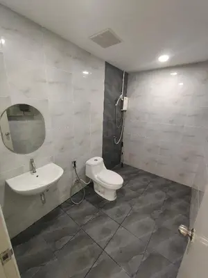 a bathroom with a sink and a toilet and a mirror at The White House Chalong in Chalong