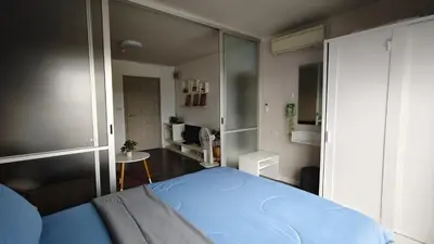 a bedroom with a blue bed in a room at D Condo mine Kathu in Kathu