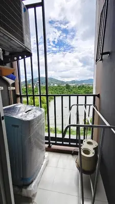 a room with a balcony with a view of the water at D Condo mine Kathu in Kathu