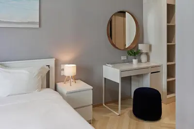 a bedroom with a bed and a desk and a mirror at Brand New apartments, 60 sqm, BangTao beach in Bang Tao Beach
