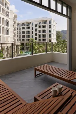 a balcony with a view of a building at Brand New apartments, 60 sqm, BangTao beach in Bang Tao Beach