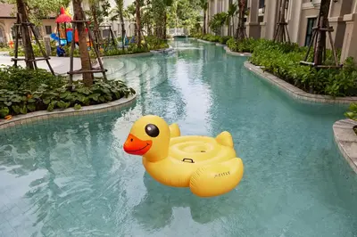 a pool with two rubber ducks in the water at Brand New apartments, 60 sqm, BangTao beach in Bang Tao Beach