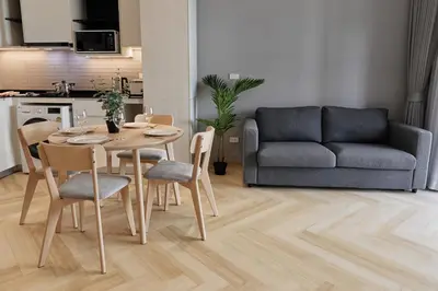 a living room with a table and chairs and a couch at Brand New apartments, 60 sqm, BangTao beach in Bang Tao Beach