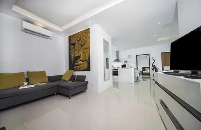 a large living room with a couch and a kitchen at Villa with private pool in Kamala in Kamala Beach