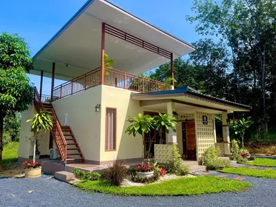 a house with a balcony and a staircase at The wells house krabi in Klong Muang Beach