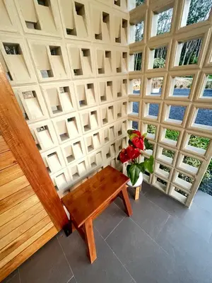 a room with a table and a vase of flowers at The wells house krabi in Klong Muang Beach