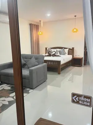 a living room with a bed and a couch at The wells house krabi in Klong Muang Beach