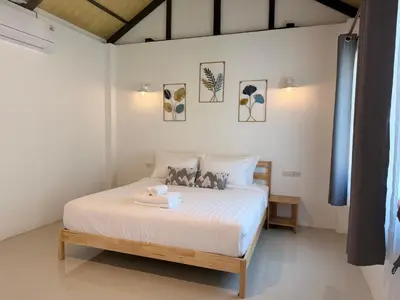 a bedroom with a large white bed in a room at Sea Escape Koh Yao Yai in Ko Yao Yai