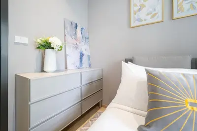 a bedroom with a bed and a dresser with flowers on it at The Title Legendary Condo with a large terrace 308 in Bang Tao Beach