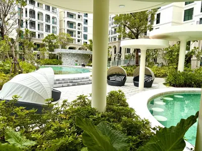 a pool at a hotel with a building in the background at The Title Legendary Condo with a large terrace 308 in Bang Tao Beach