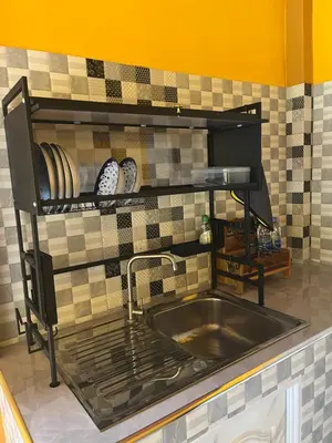 a kitchen with a sink and a tiled wall at SeaMountain Kohyao Noi in Ko Yao Noi