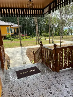 a porch with a welcome mat on the floor at SeaMountain Kohyao Noi in Ko Yao Noi