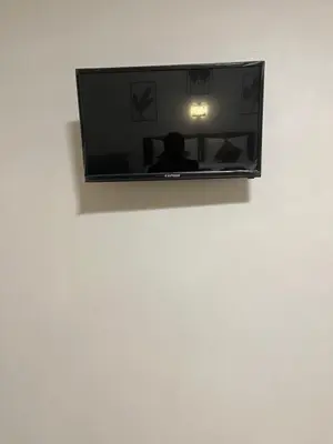 a flat screen tv hanging on a white wall at SeaMountain Kohyao Noi in Ko Yao Noi